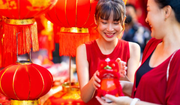 Asian,Family,Mother,And,Daughter,Holding,Red,Shopping,Bag,During