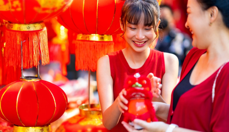 Asian,Family,Mother,And,Daughter,Holding,Red,Shopping,Bag,During