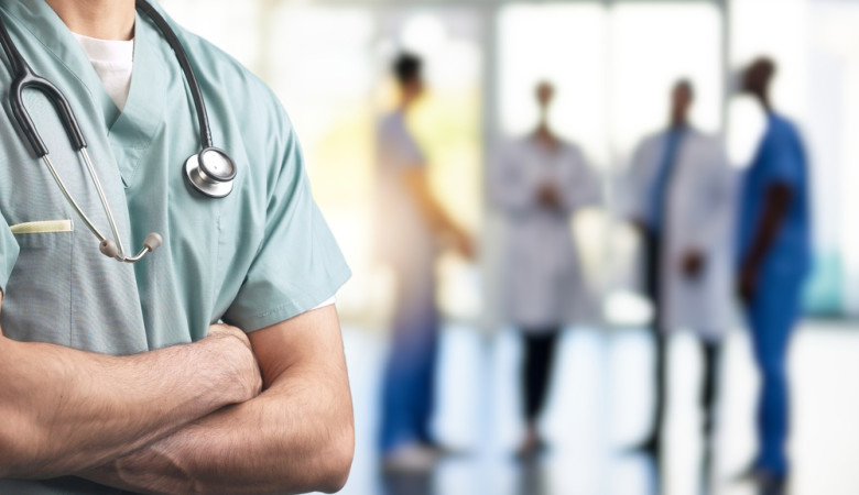 A,Close-up,Of,A,Healthcare,Professional,In,Scrubs,With,Arms